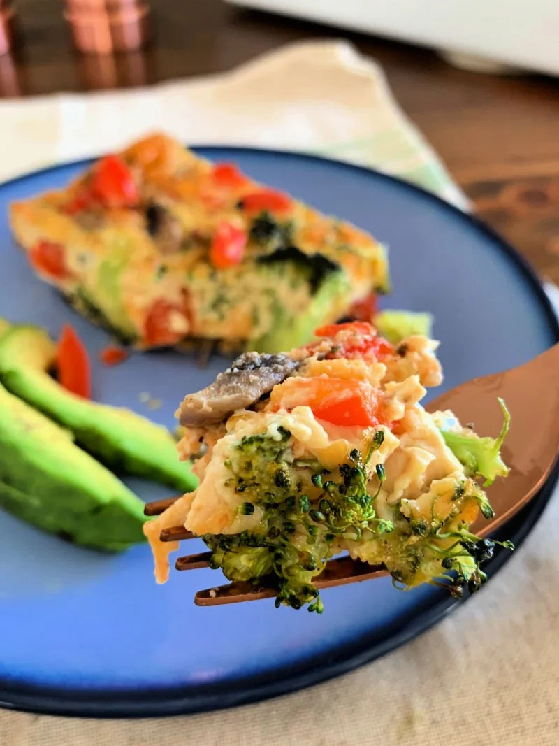 This easy low carb veggie breakfast casserole has 10 eggs, colorful vegetables, and melted cheese — baked in 40 minutes and meal preps all week. 14g protein per slice