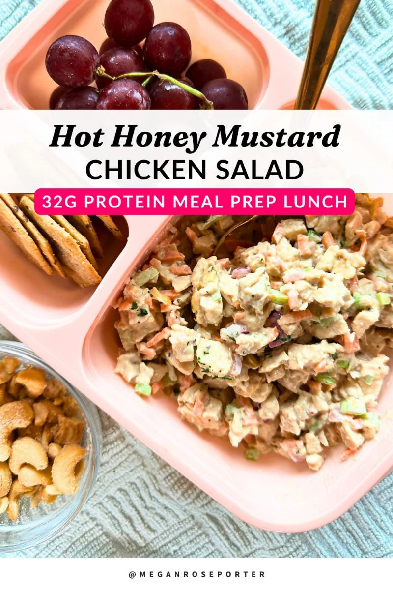 Honey mustard chicken salad with cashews, carrots, celery, and red onion in a glass bowl with avocado oil mayo dressing