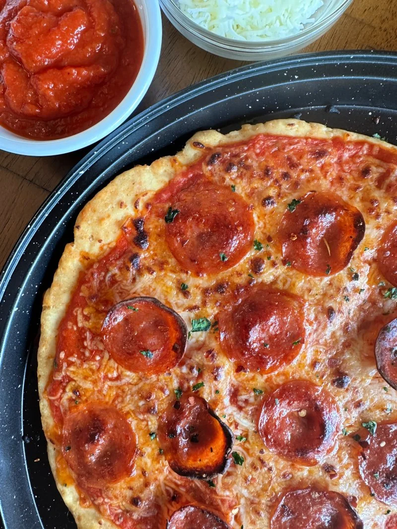 Crispy chicken crust pizza made with a gluten free high protein pizza crust that’s keto-friendly and ready in under 30 minutes.