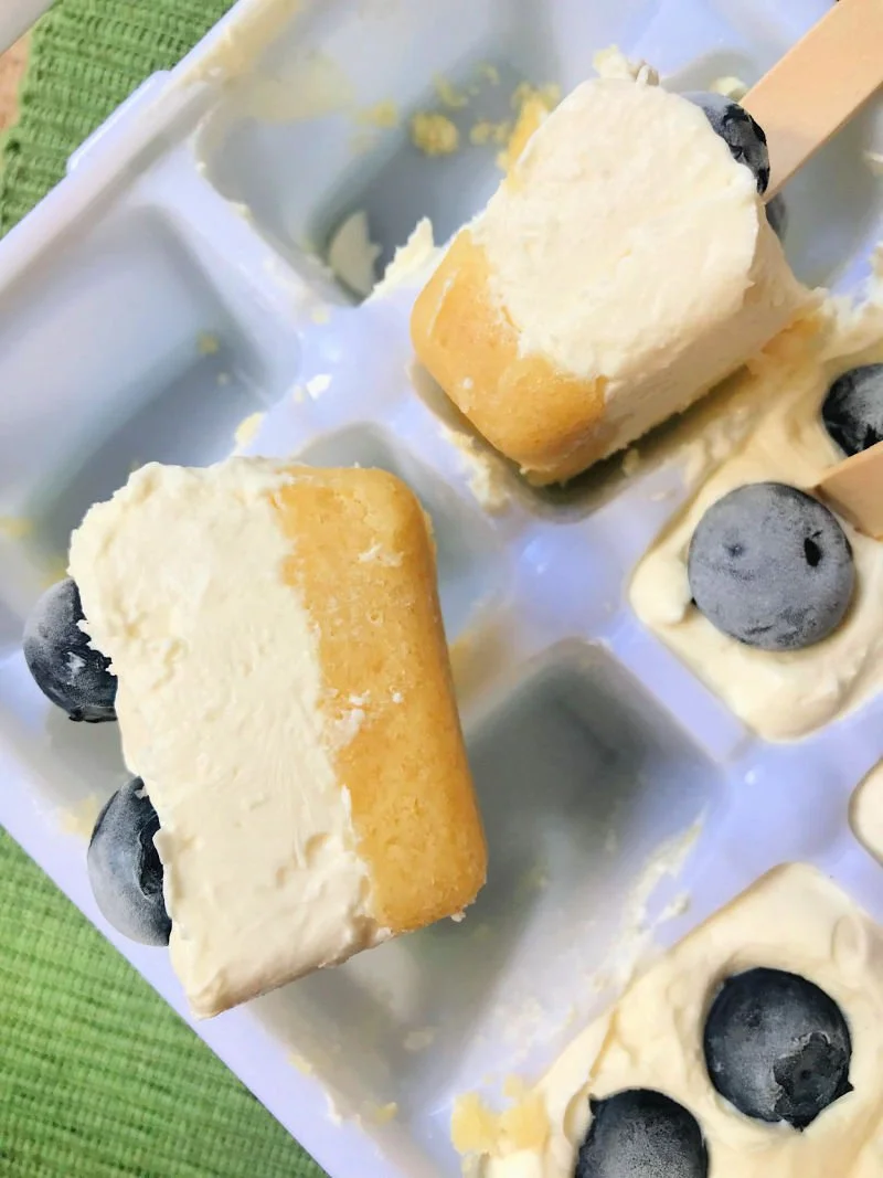 No-bake keto cheesecake bites made in an ice cube tray with almond flour crust and blueberries on top