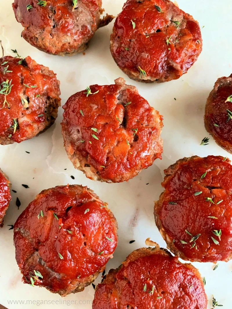 Keto meatloaf muffins in muffin pan with sugar-free ketchup