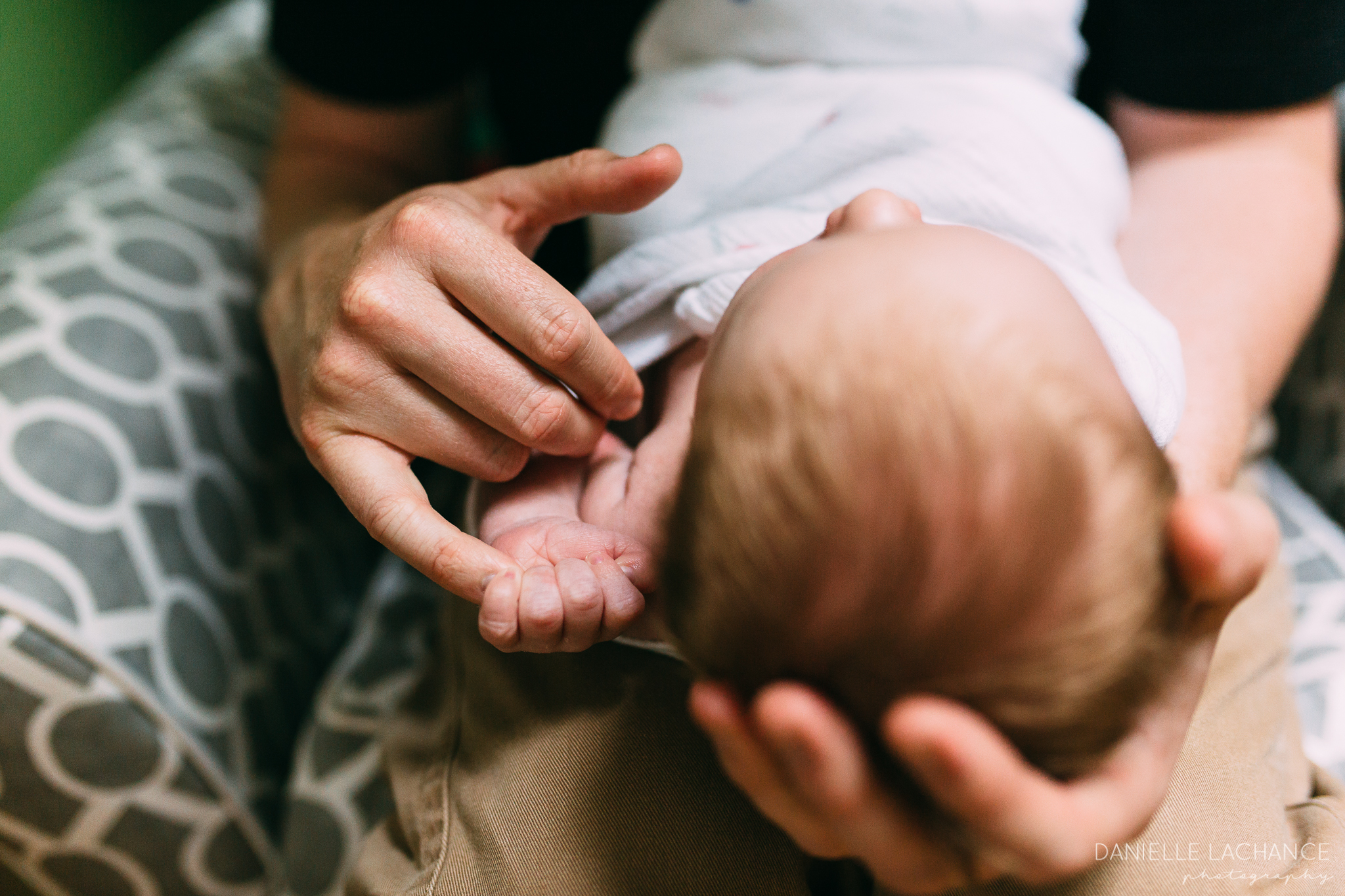 baby holding dad's finger