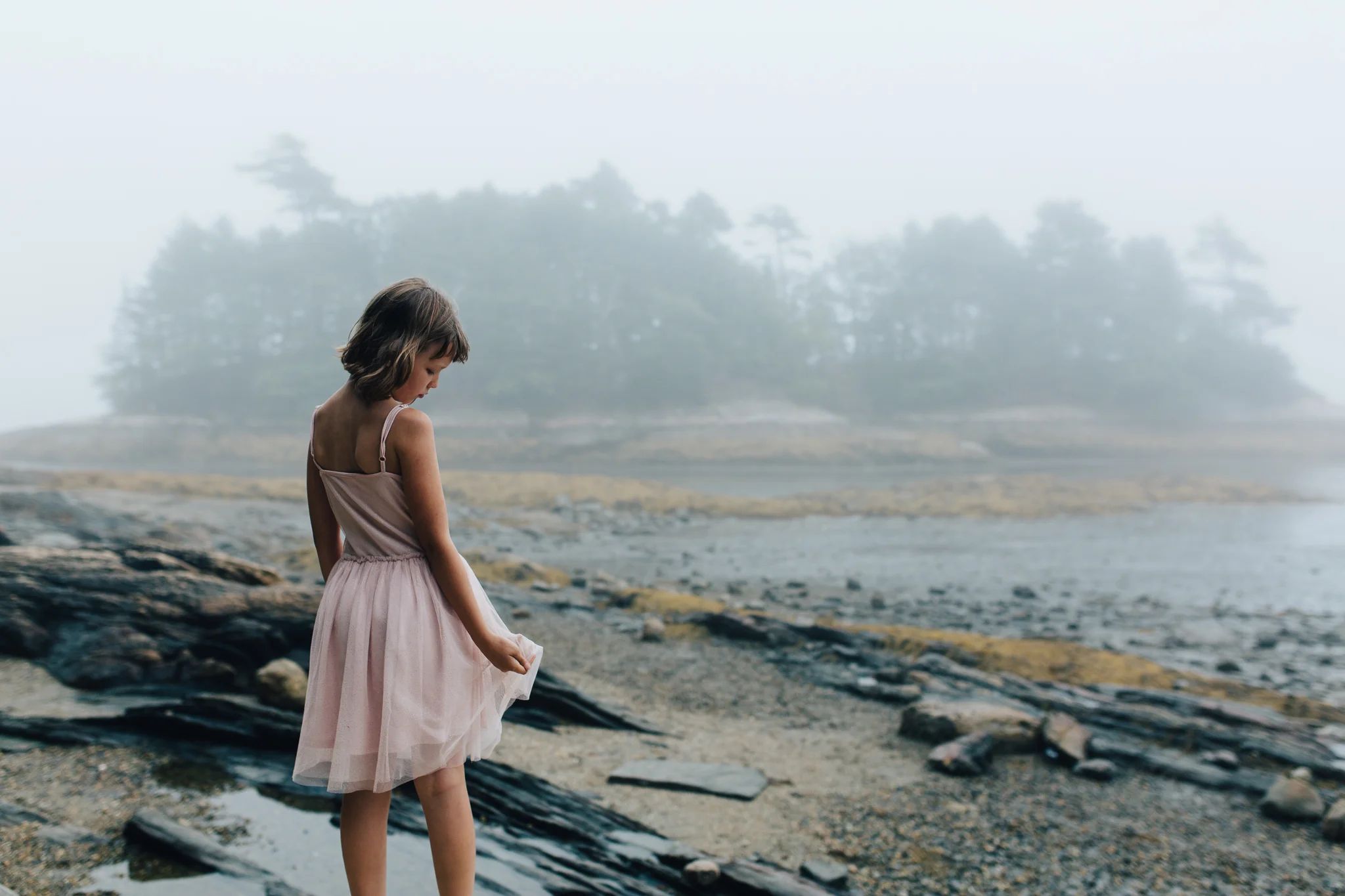 girl along the foggy midcoast beach