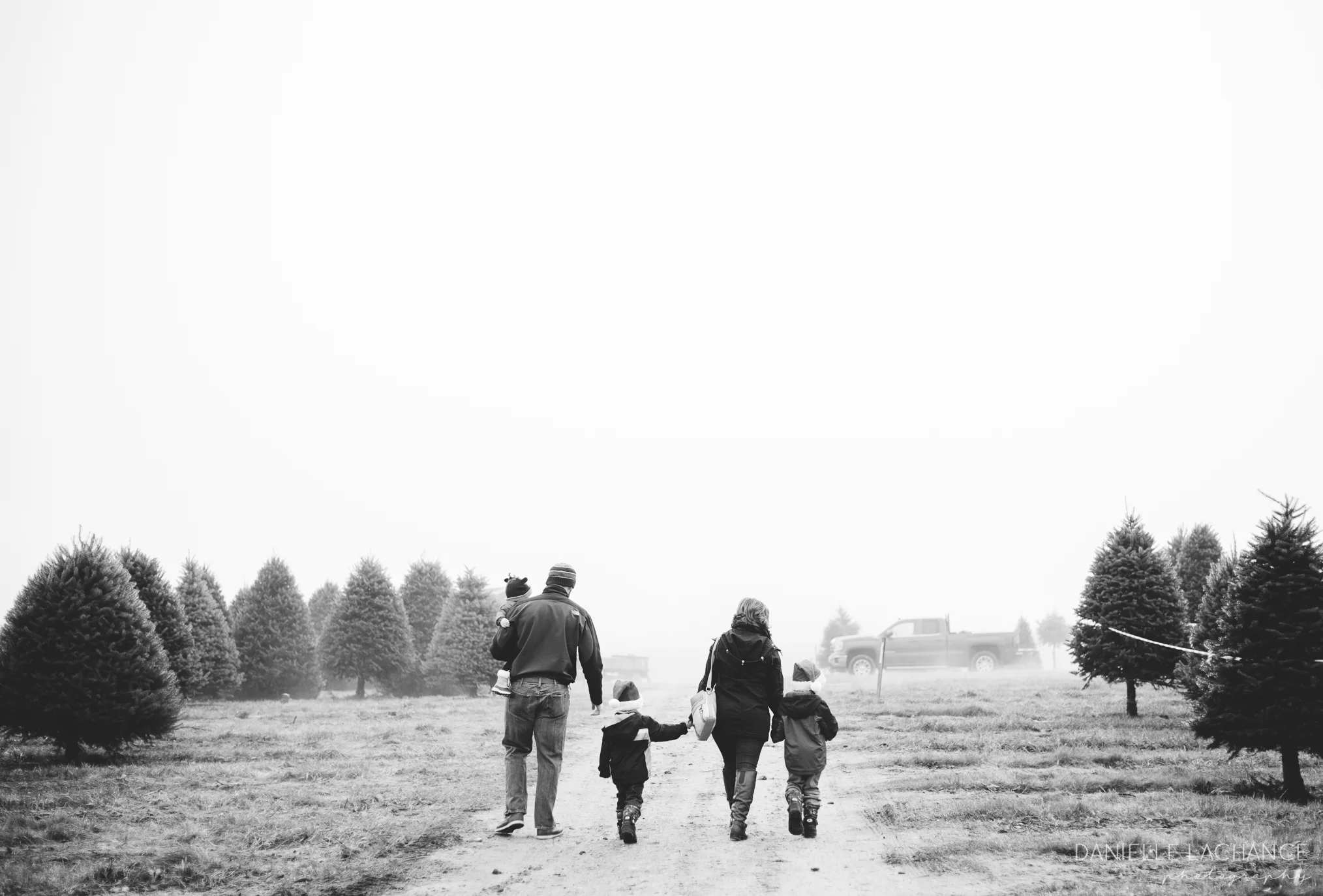 Maine family walking through tree farm in Dayton, Maine