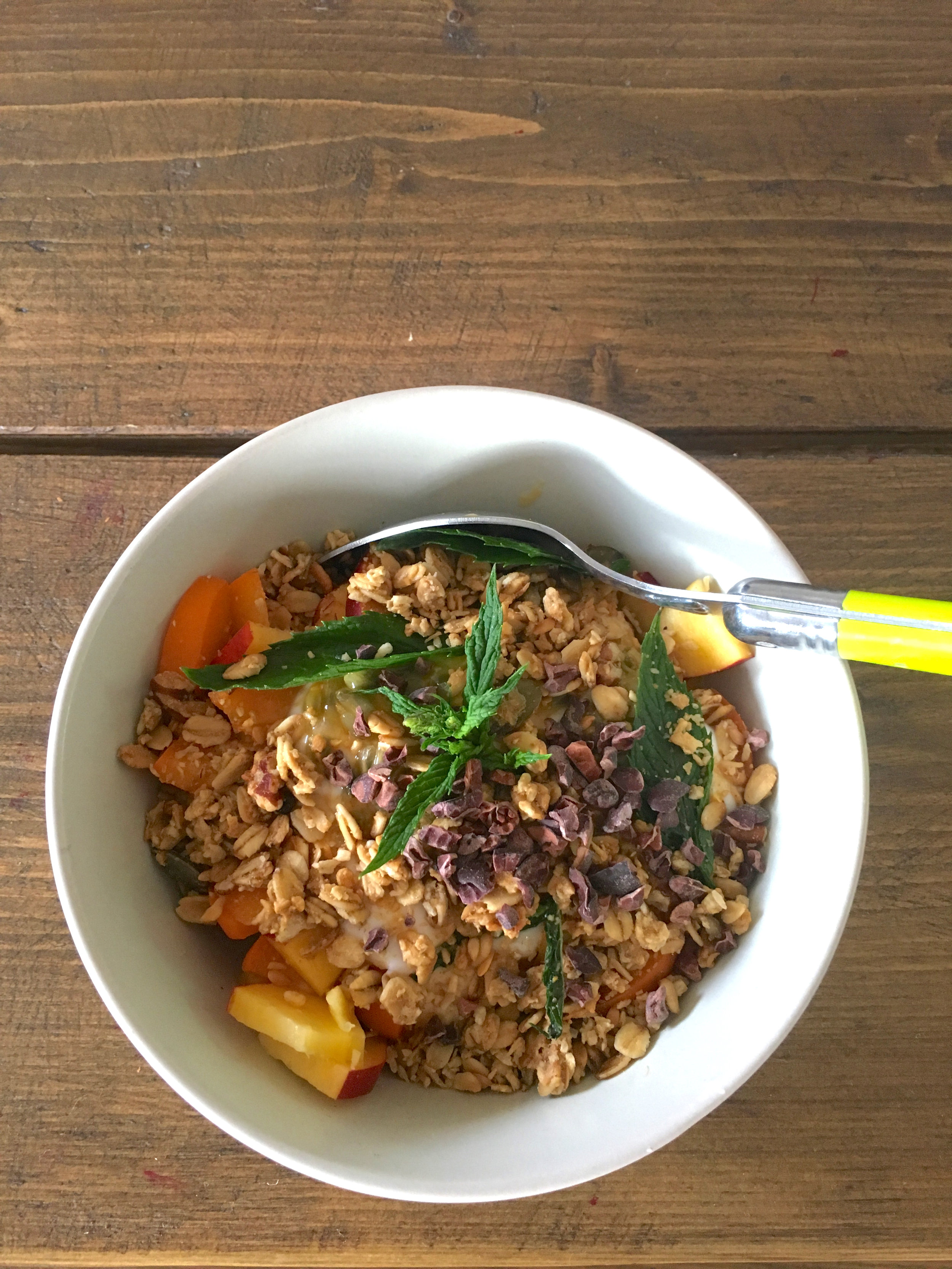 Granola with peaches, apricots, passion fruit, raw cocoa, coconut yogurt