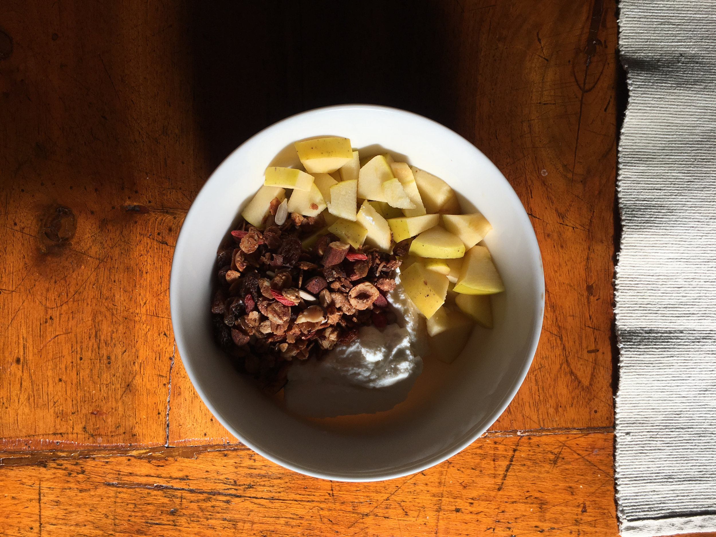 Homemade granola with fresh ricotta, apples and bananas