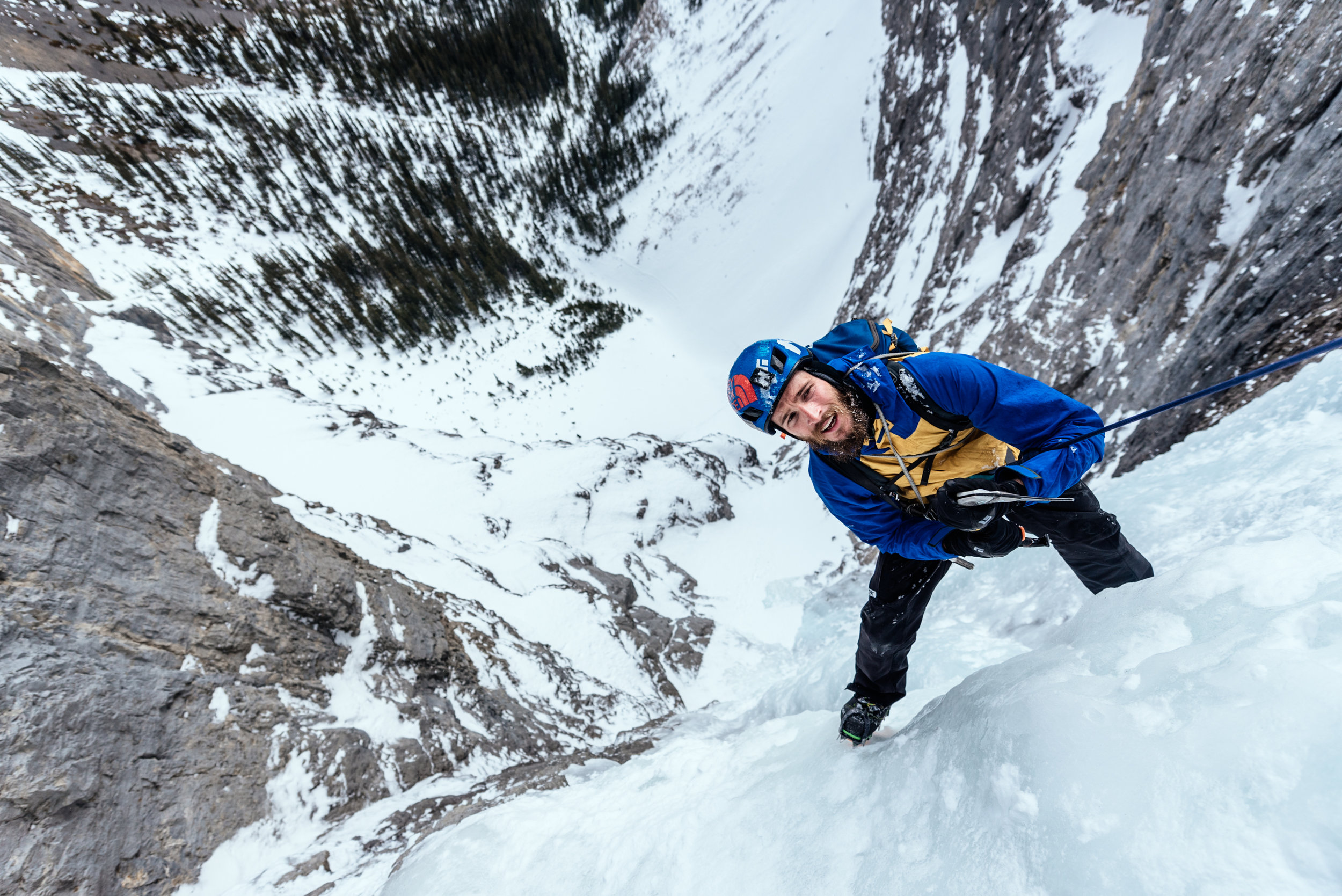Christian hangs high above the valley floor, contemplating his next move with only one tool.
