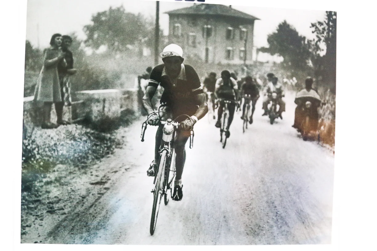 Gino Bartali racing the Giro di Lombardia past Hotel Il Perlo...and the owner's teenage aunts watching him race by!