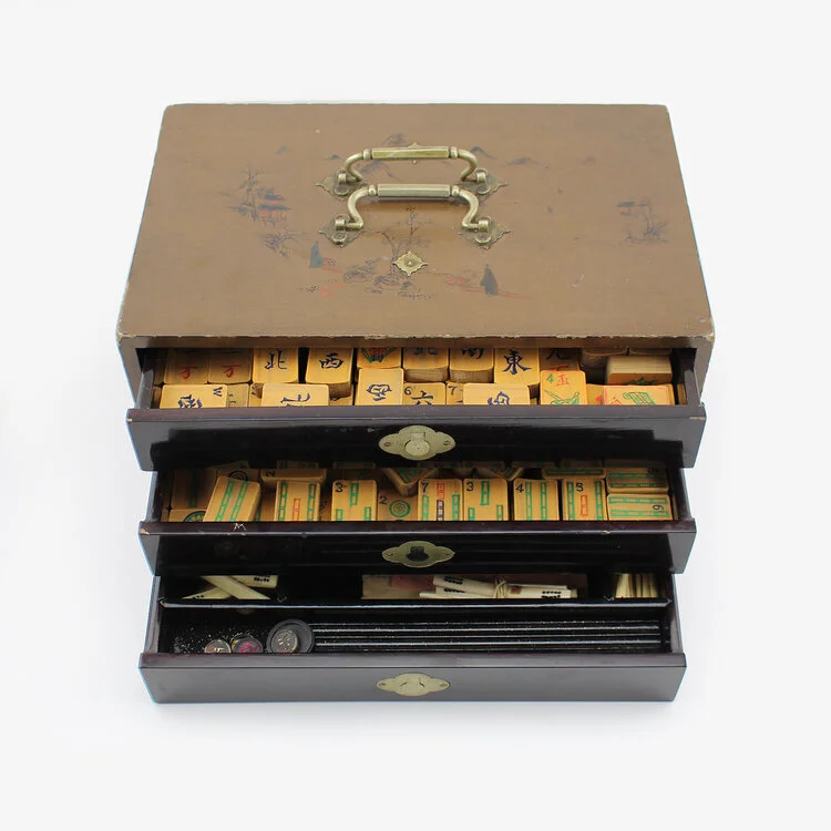 Mahjong set in lacquered box, circa 1900. Consists of complete set of 144 bone and bamboo Mahjong tiles, dice, counters, markers, and wooden tile holders. Tiles adorned with both calligraphy and Western numbers as well as artwork and figures. Housed…