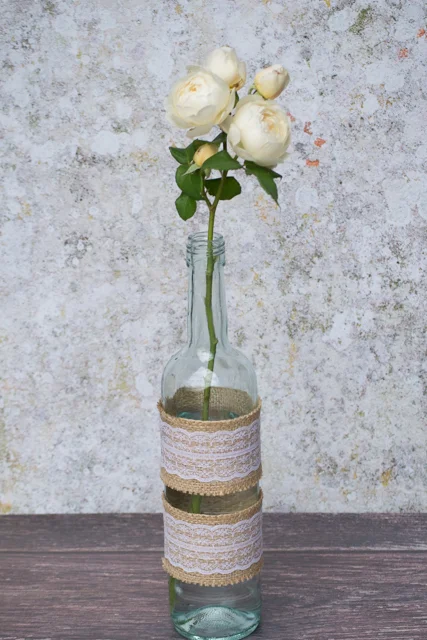 Multi-headed rose in a decorated wine bottle