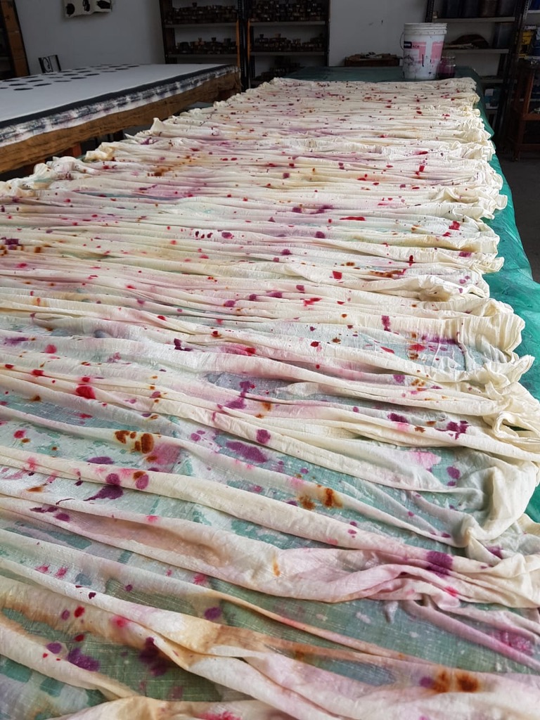  Handpainted fabric has been painted and is wet and laid out to dry in the air. Dryers aren’t used in the processes, so less electricity. 