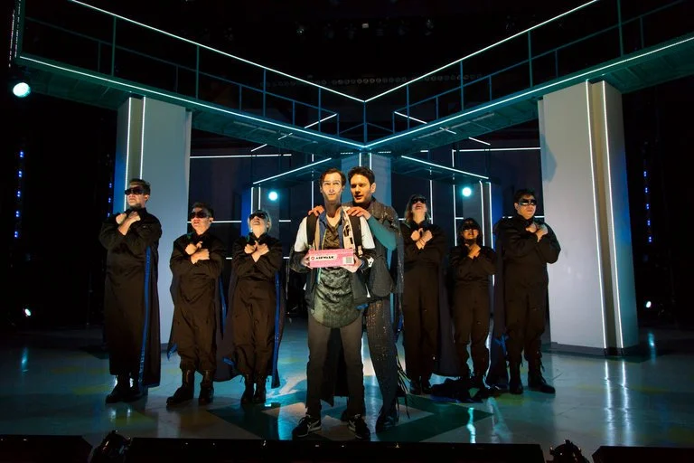 Will Connolly (center) as a high school student who takes steps to turn cool in the Two Rivers Theater production of “Be More Chill.” Credit T. Charles Erickson