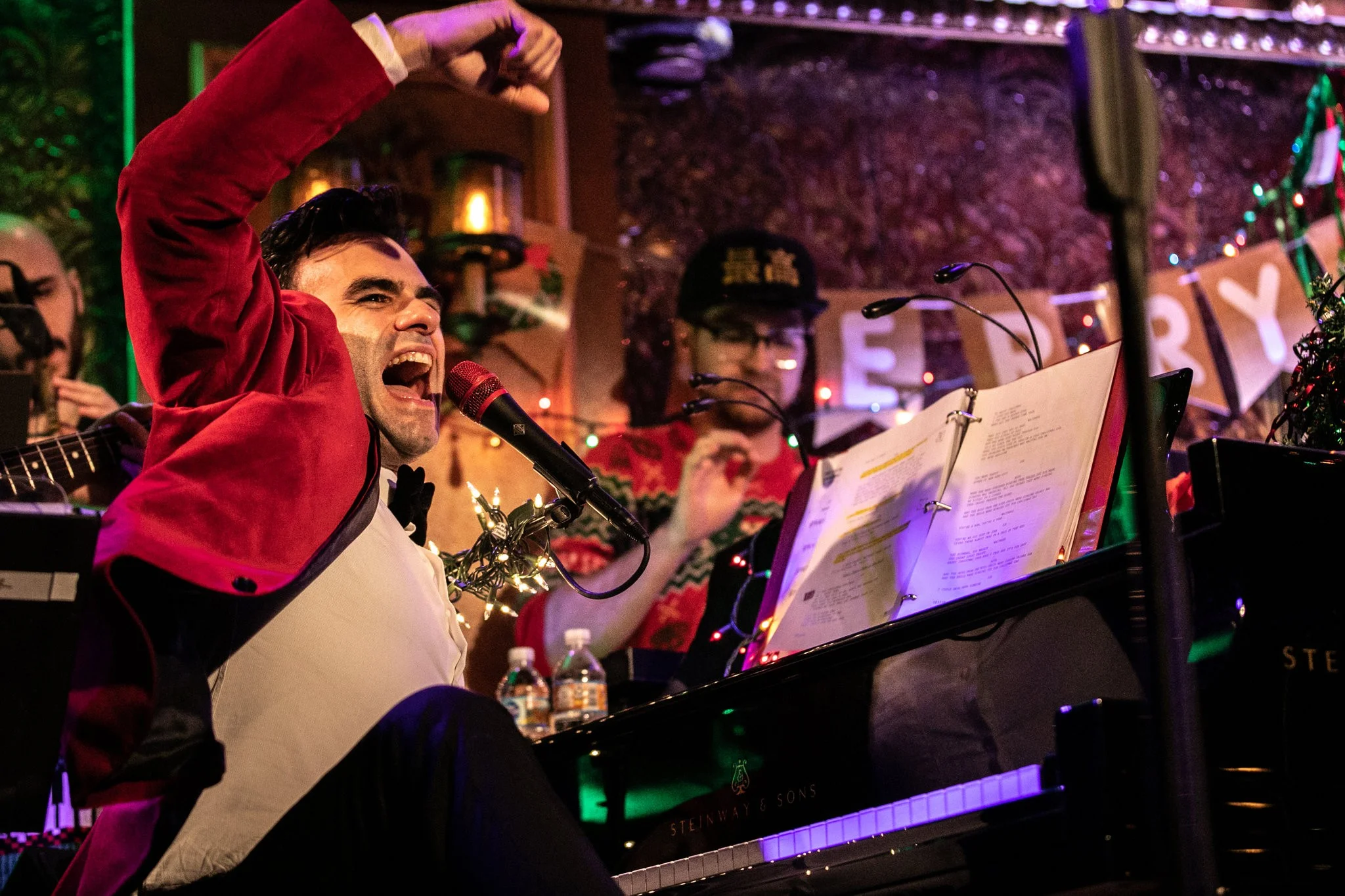 Joe Iconis at his annual Christmas show at Feinstein’s/54 Below, which brings together his regular collaborators, many of whom, like him, have been waiting for their break in New York theater. Credit Jeenah Moon for The New York Times