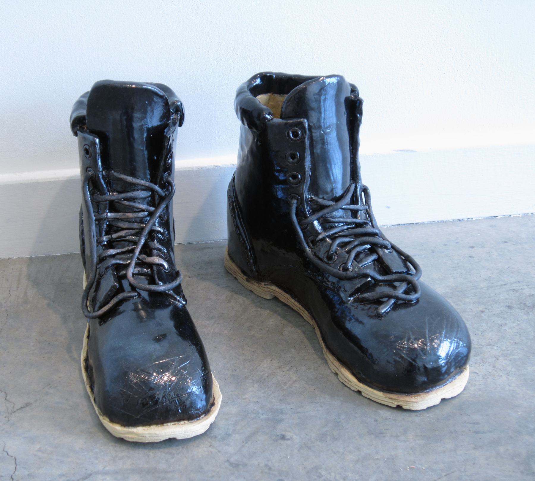 ERIK SCOLLON Empty Boots, 2013, glaze on stoneware, 9" x 11 1/2" x 4" (each)