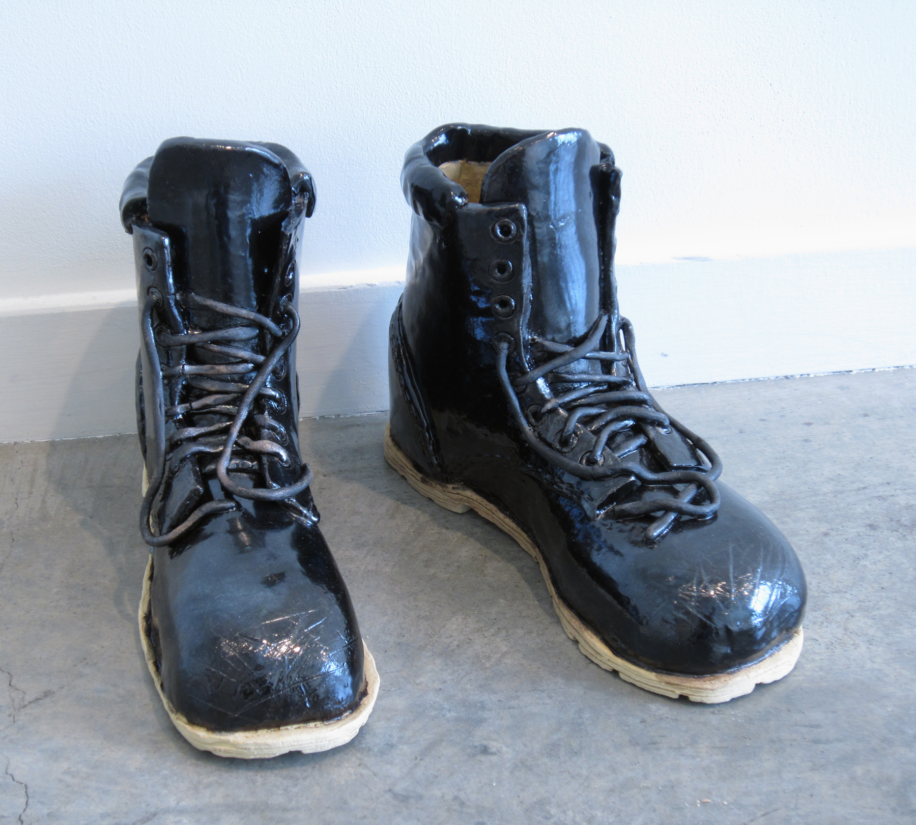   ERIK SCOLLON   Empty Boots,&nbsp; 2013, glaze on stoneware, 9" x 11 1/2" x 4" (each) 