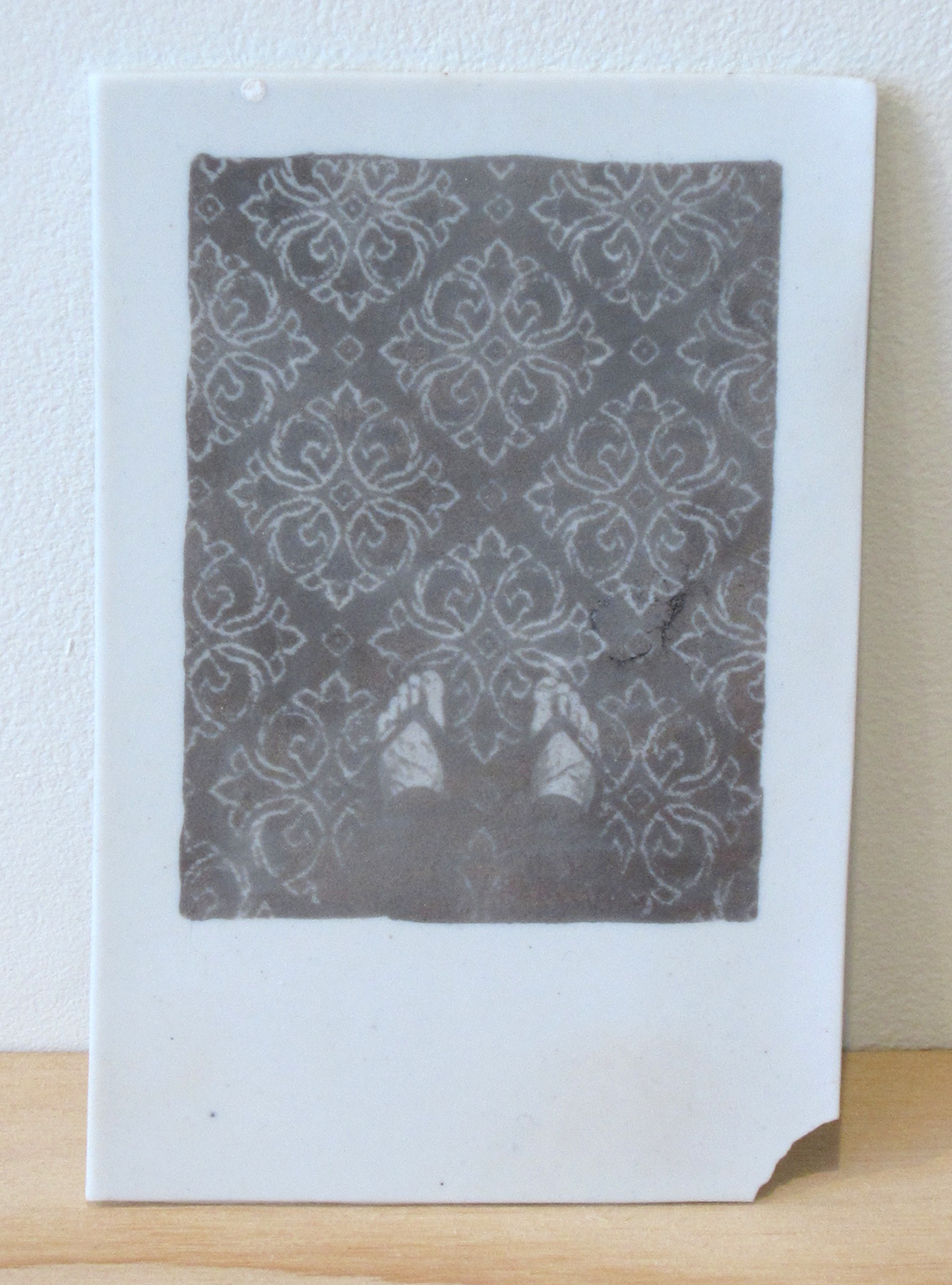 ERIK SCOLLON Here, Now, 2013, silver luster on porcelain, 5 1/4" x 3 1/2" x 1/16"