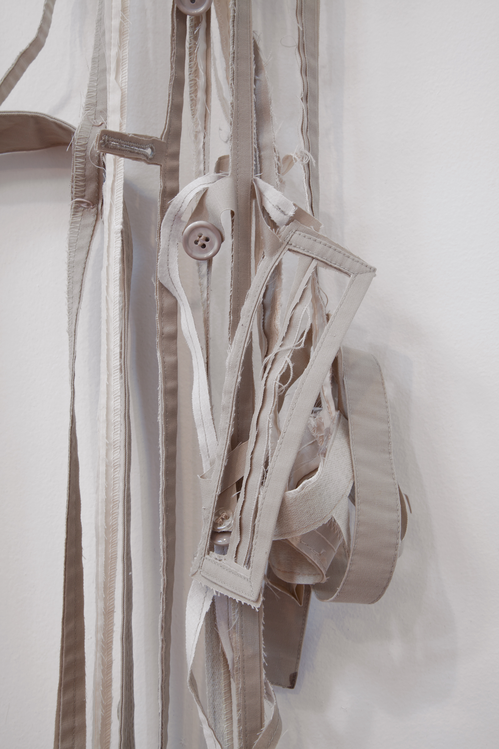   ANNA SEW HOY  (detail)&nbsp; beige/cream , fired stoneware, trench coat and resin finger hook, 55" x 17" x 3.5", 2012 