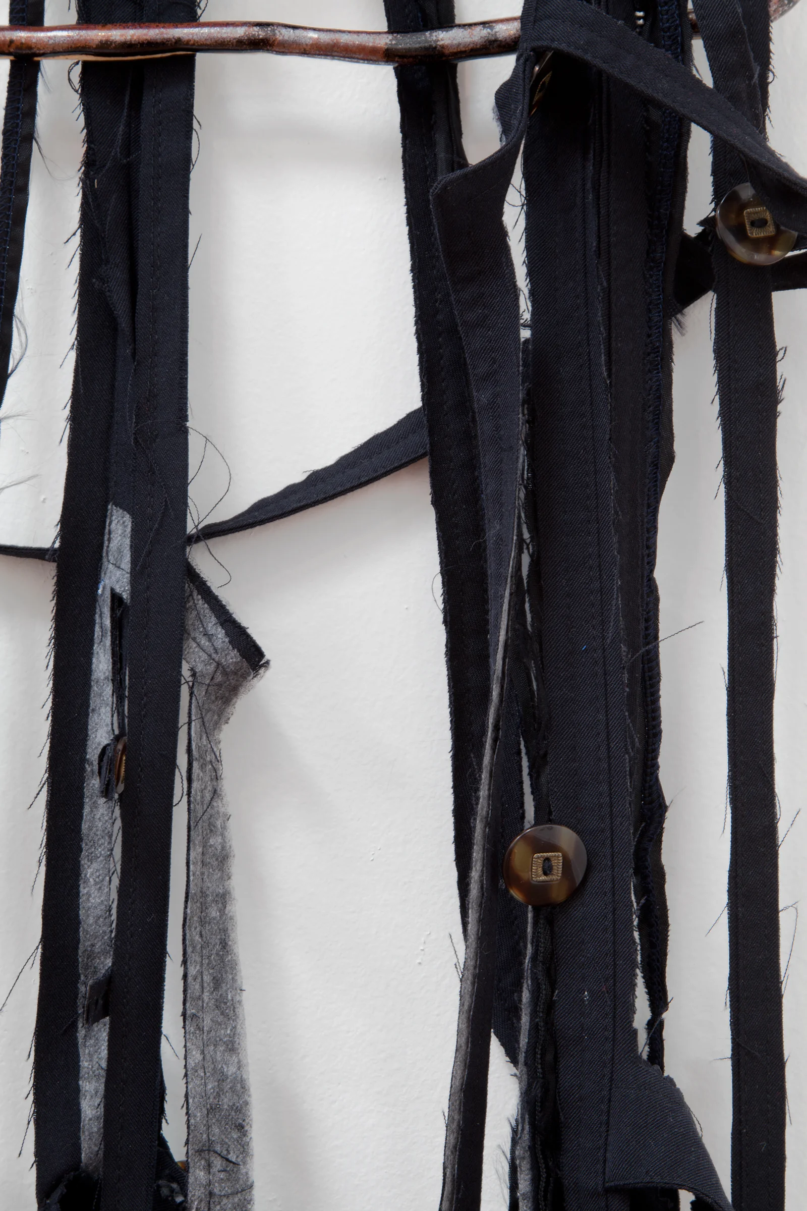 ANNA SEW HOY (detail) black/noire , fired stoneware, trench coat and resin finger hook, 62.5" x 16.5" x 4", 2012