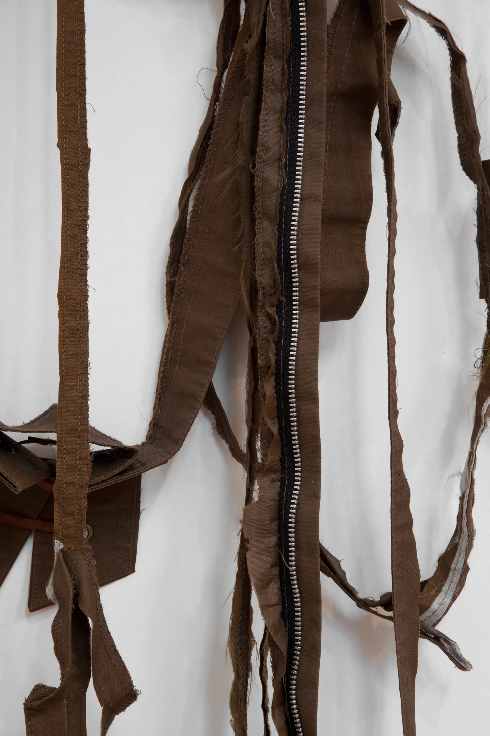 ANNA SEW HOY (detail) chocolate/chocolat , fired stoneware, trench coat and resin finger hook, 58.5" x 18" x 3.5", 2012