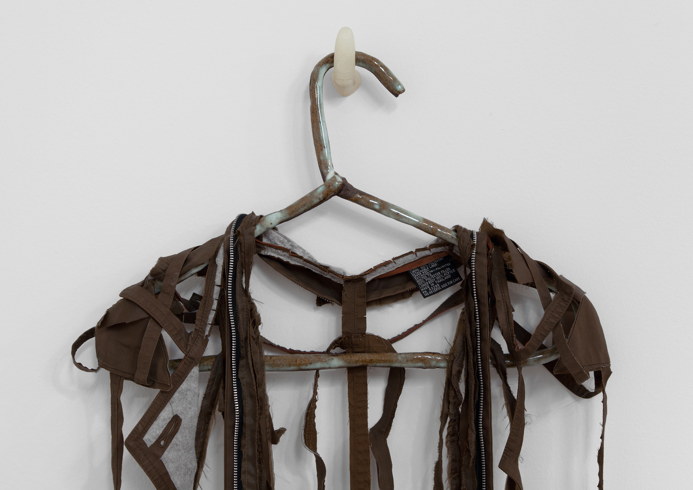   ANNA SEW HOY  (detail)  chocolate/chocolat , fired stoneware, trench coat and resin finger hook, 58.5" x 18" x 3.5", 2012 