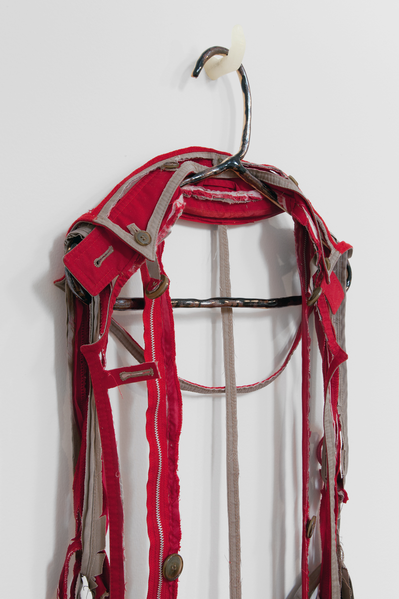   ANNA SEW HOY  (detail)  rouge/tan , fired stoneware, trench coat and resin finger hook, 58" x 17" x 5", 2012 