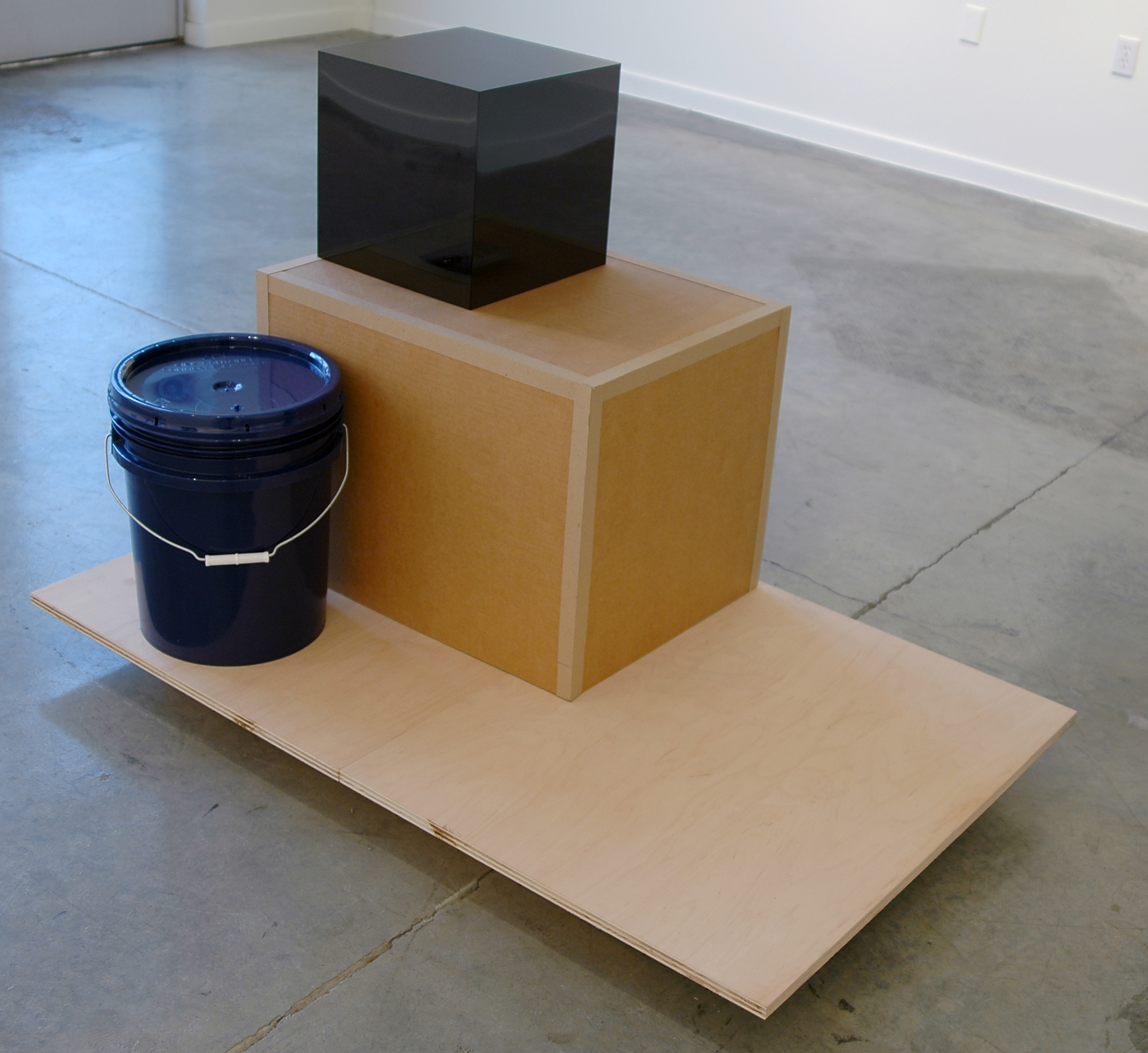   PABLO GUARDIOLA   San Francisco, don't be afraid of the vastness of the world, of the immensity of the sea. Your thing is the air  wood, cardboard, blue bucket, plexiglass and postcard, 51" L x 32" W x 34.5" H, 2011 