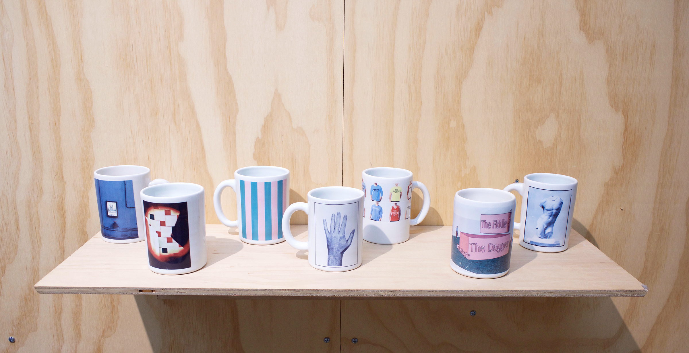  Erik Scollon Shelf #2, 2018 7 individual handmade porcelain mugs with artist made ceramic decals, glaze and wooden shelf, 6” x 32” x 11" 