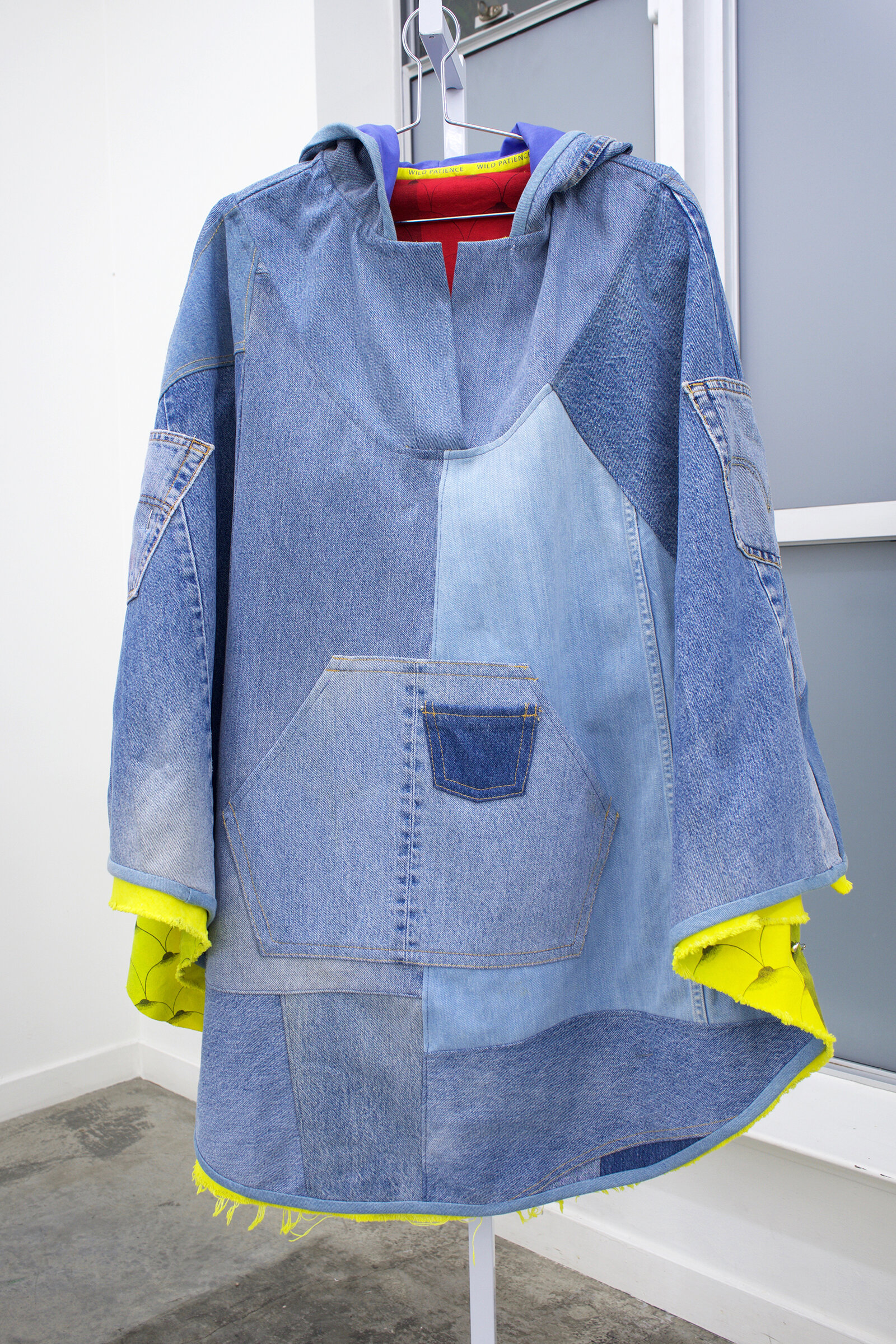  AMANDA CURRERI  Wild Patience Pocket Poncho,  2019 Recycled denim, screen printed cotton, synthetic dyed and digitally printed cotton, 33” x 43”    