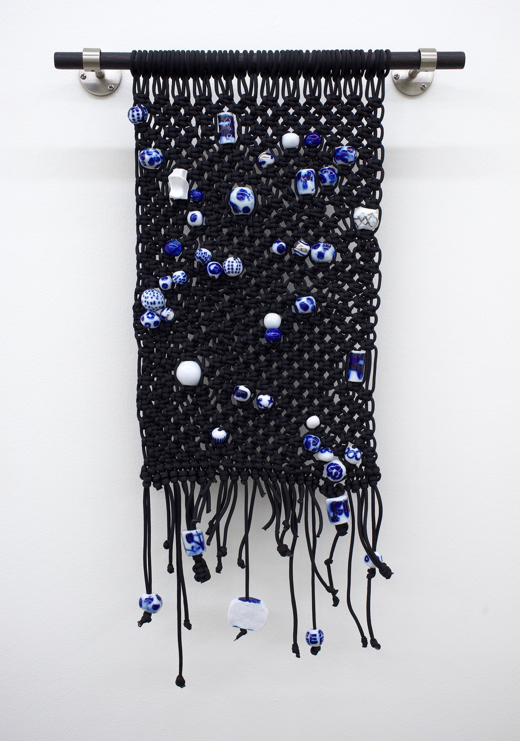   Atlas , 2021 Paracord, glazed stoneware and porcelain beads with digital decals, charred and stained wood, metal mounts 28.5” x 18” 