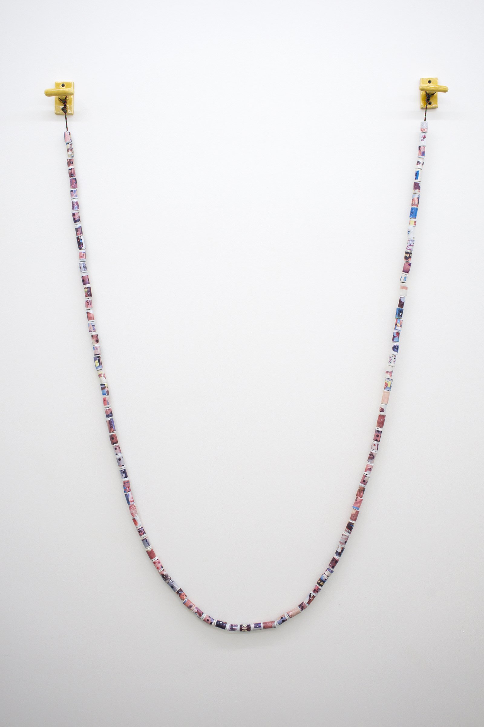   Connections II , 2022 Glazed porcelain beads with digital decals, glazed stoneware wall mounts, paracord 71” x 42” 