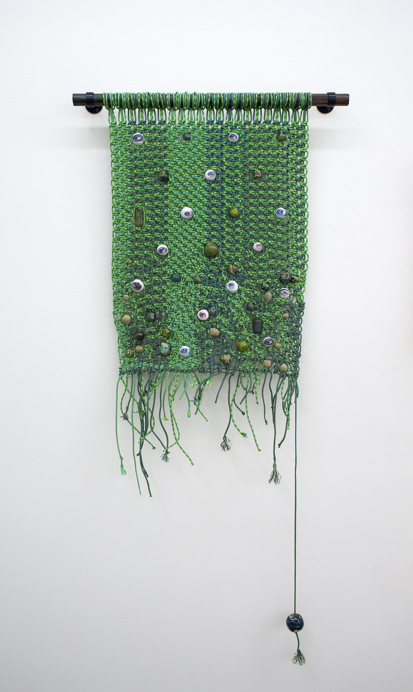   Ramble , 2022 Paracord, glazed stoneware and porcelain beads with digital decals, charred and stained wood, metal mounts 63.5” x 28” 