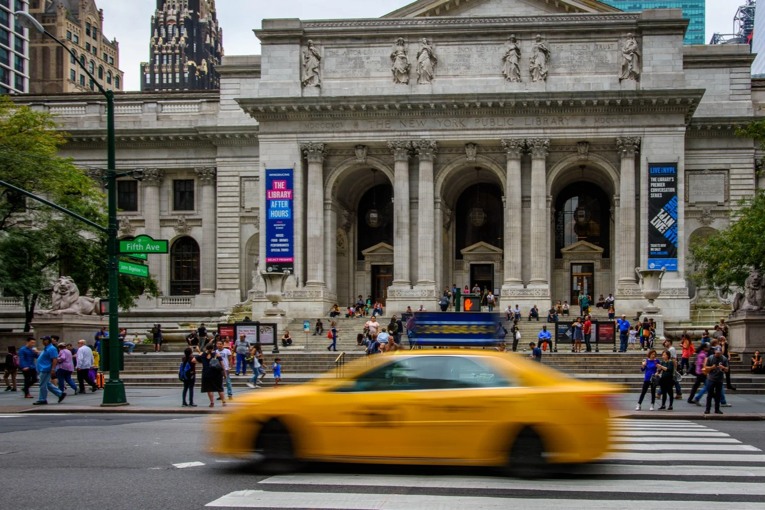 Yellow Taxi Passing New York Public Library