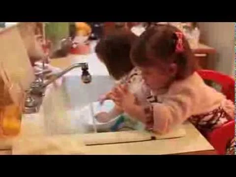 Toddler twins washing dishes and loading the dishwasher