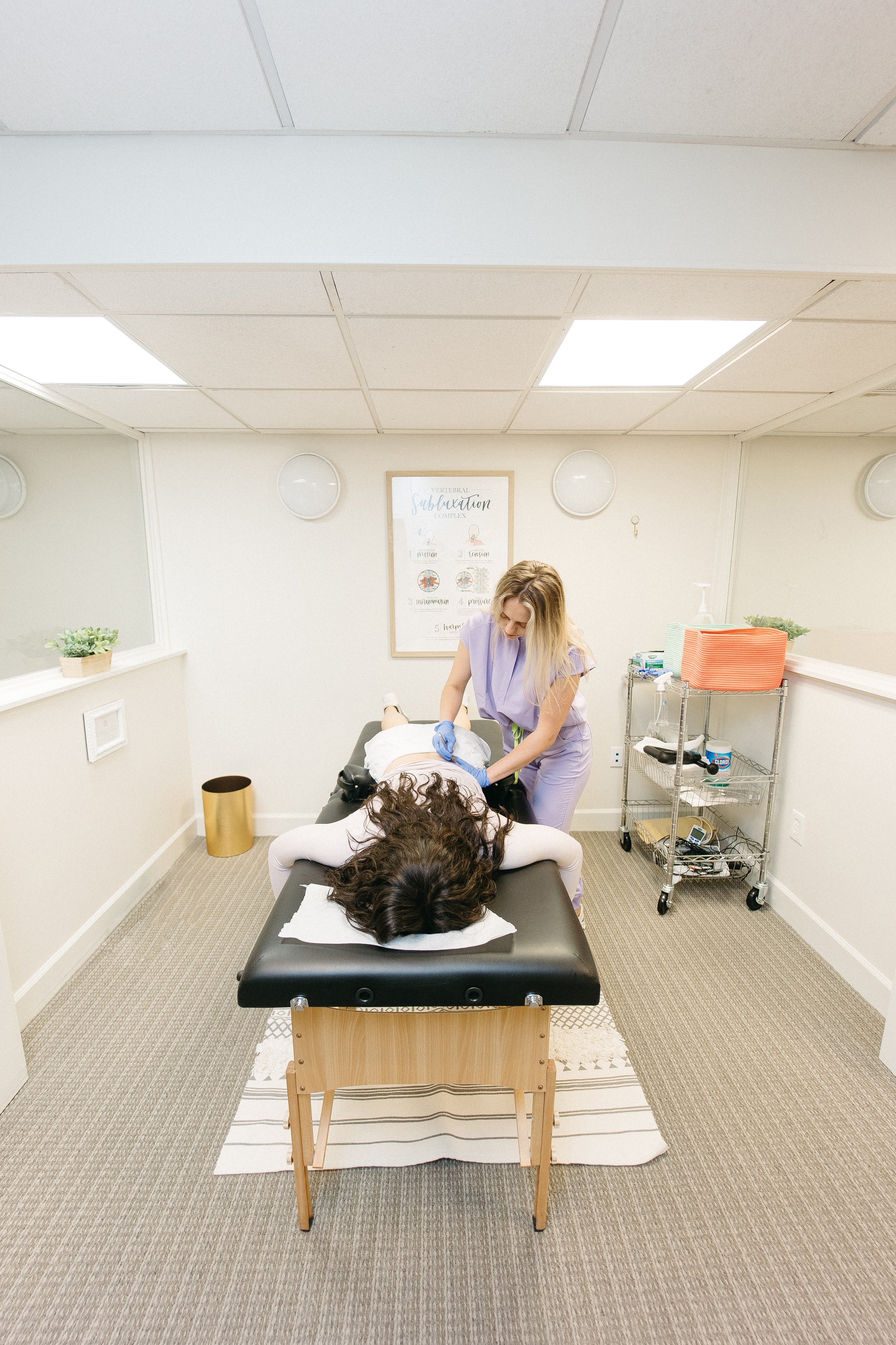  Well Adjusted Buckhead Intern provides Graston Therapy to the lower back of a patient. 