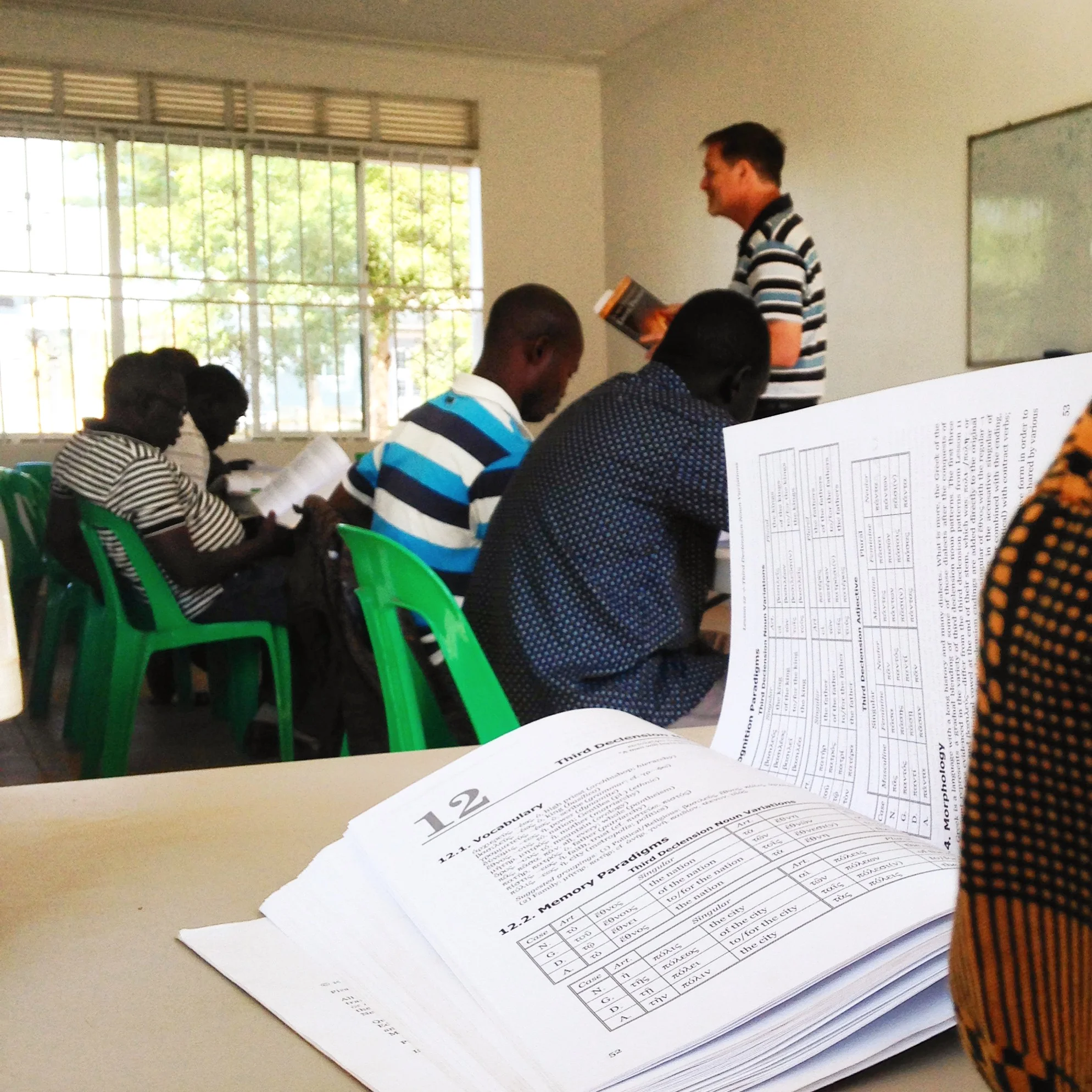 MTW Missionary Bruce Sinclair teaching New Testament Greek. Some students were using 4 languages at once: learning Greek through English instruction which they then compared to an additional Greek textbook in Arabic which made more sense to their native tribal tongue.