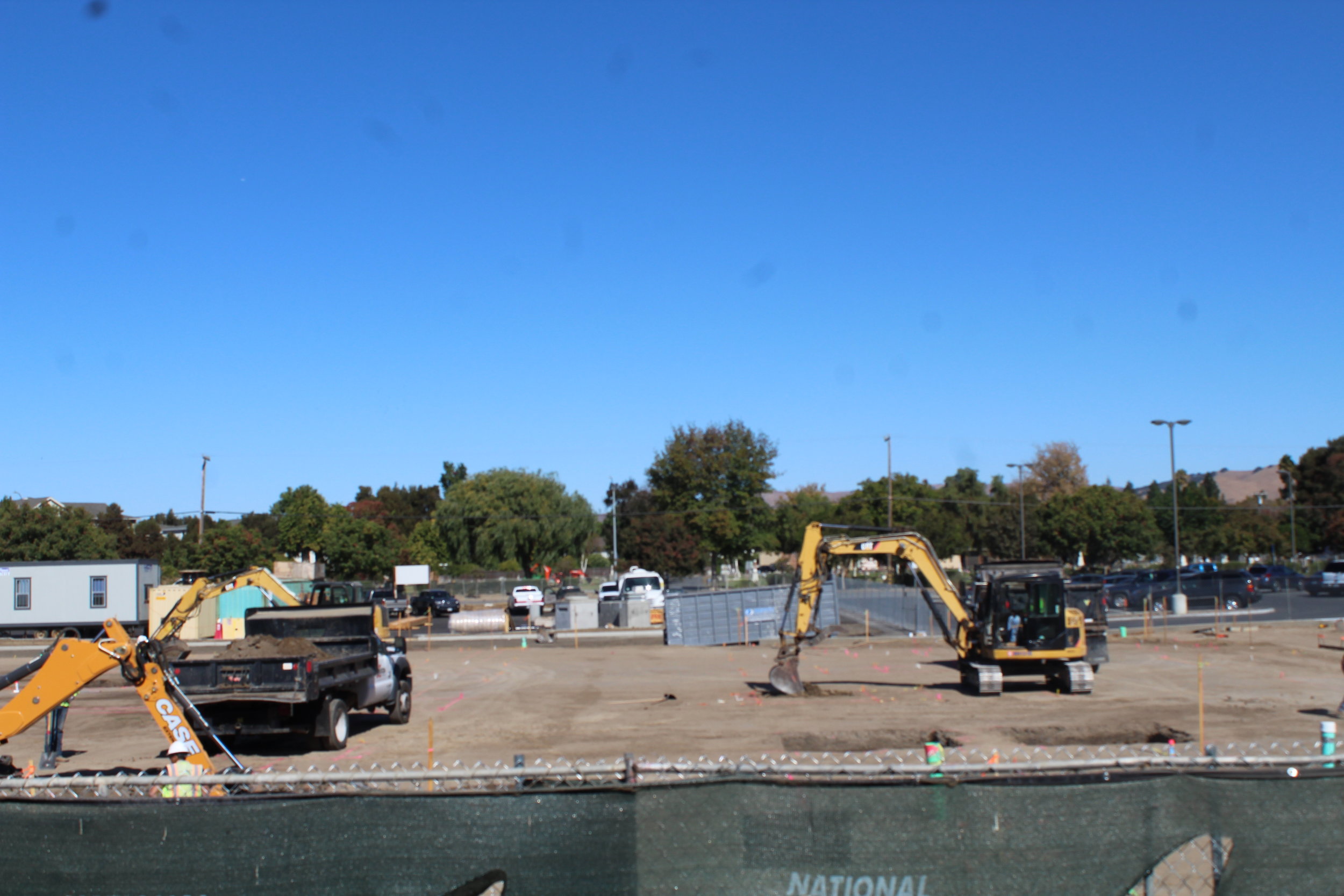 Buildings being set up and vehicles mowing the Earth.