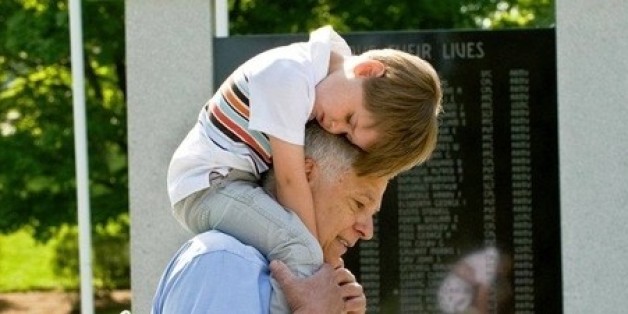 Photo by Andrea Hand Photography. Smiley's son on the shoulders of Maine Representative Mike Michaud.