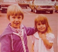 Me with my eventual husband on a pier after our dads' military homecoming in 1979.