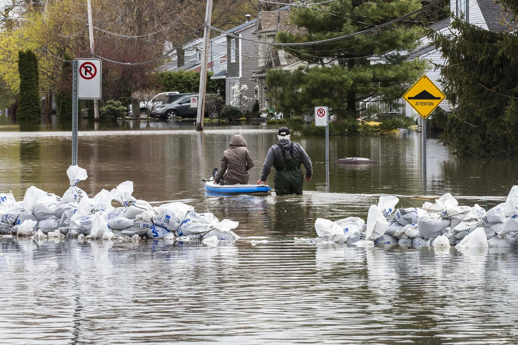  May 09, 2017 - Deux-Montagnes, Quebec, Canada: A couple uses a small boat to get to their house. (Normand Blouin/Polaris)(Normand Blouin/Polaris) 