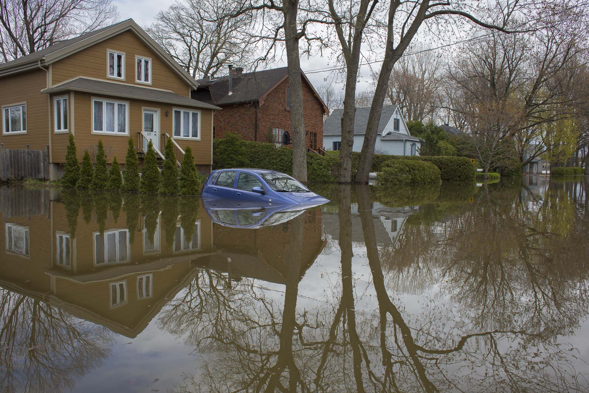  May 09, 2017 - Deux-Montagnes, Quebec, Canada: A car is flooded in front of a house. A common scene in Deux-Montagnes (Normand Blouin/Polaris) 
