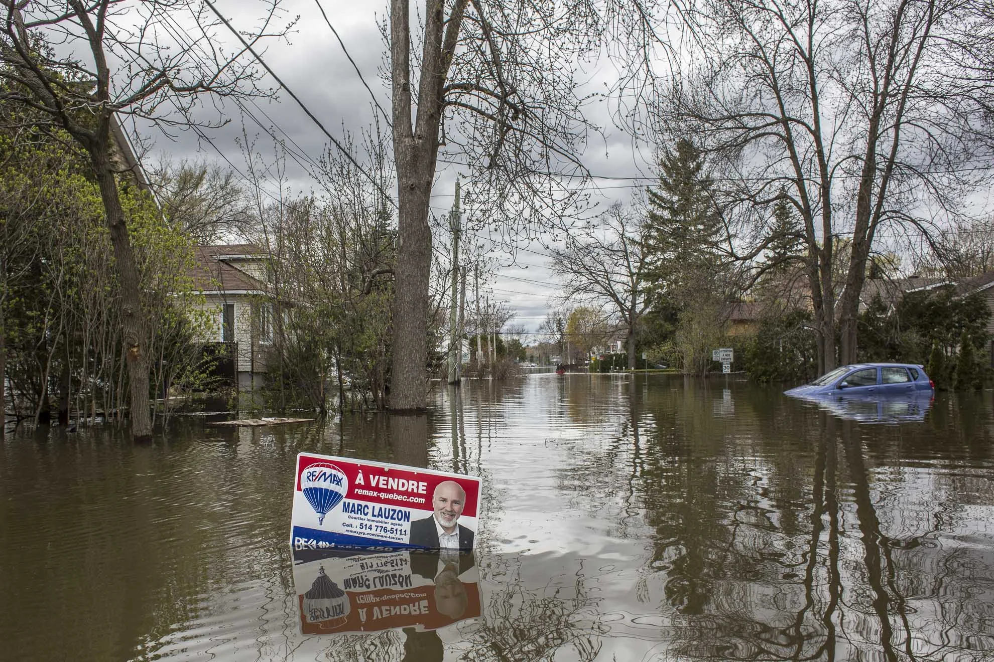  May 09, 2017 - Deux-Montagnes, Quebec, Canada: A sign for sale stand in the middle of a flooded street.(Normand Blouin/Polaris) 