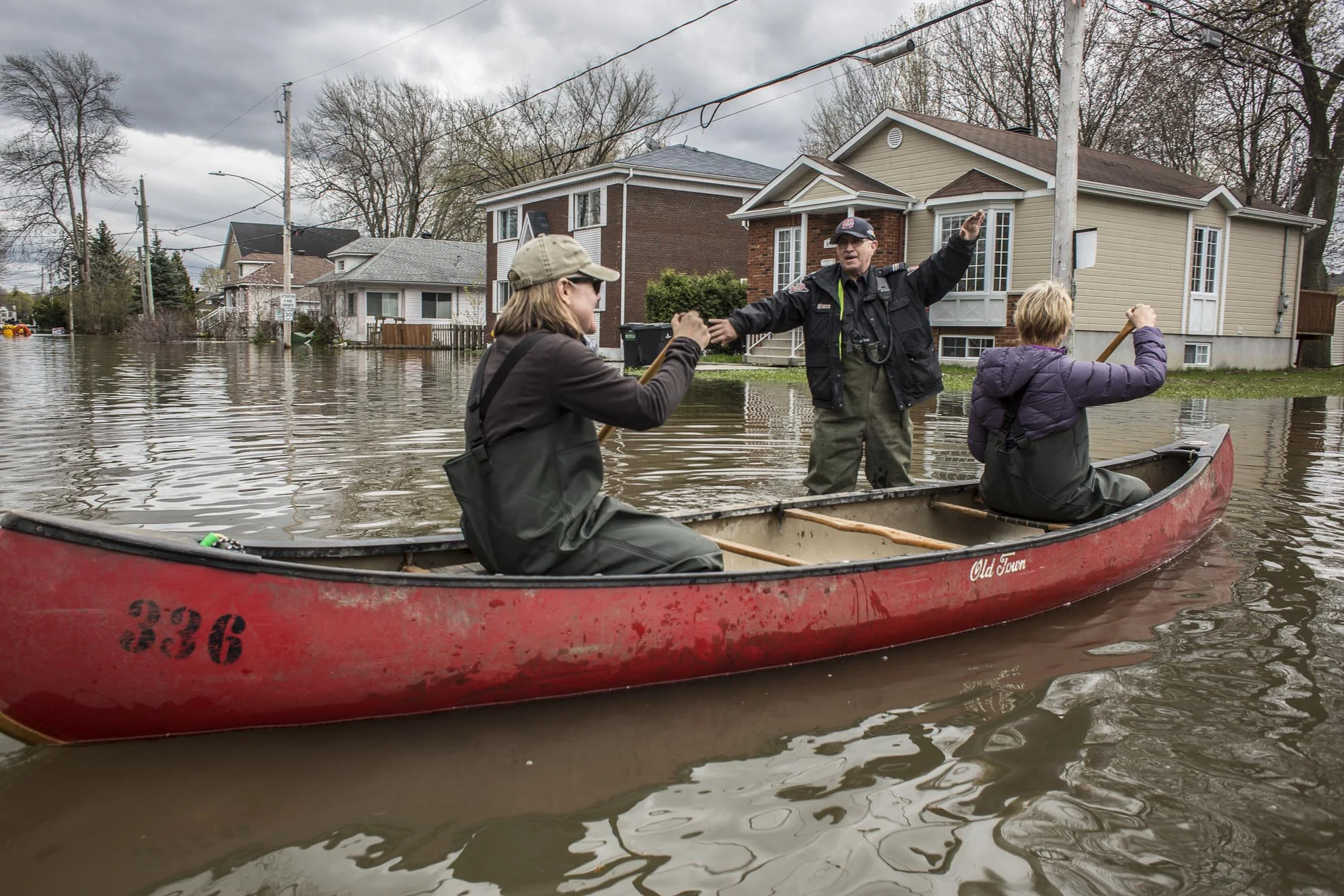  May 09, 2017 - Deux-Montagnes, Quebec, Canada: A city security  officer pretends to do traffic to residents in a canoe. (Normand Blouin/Polaris) 