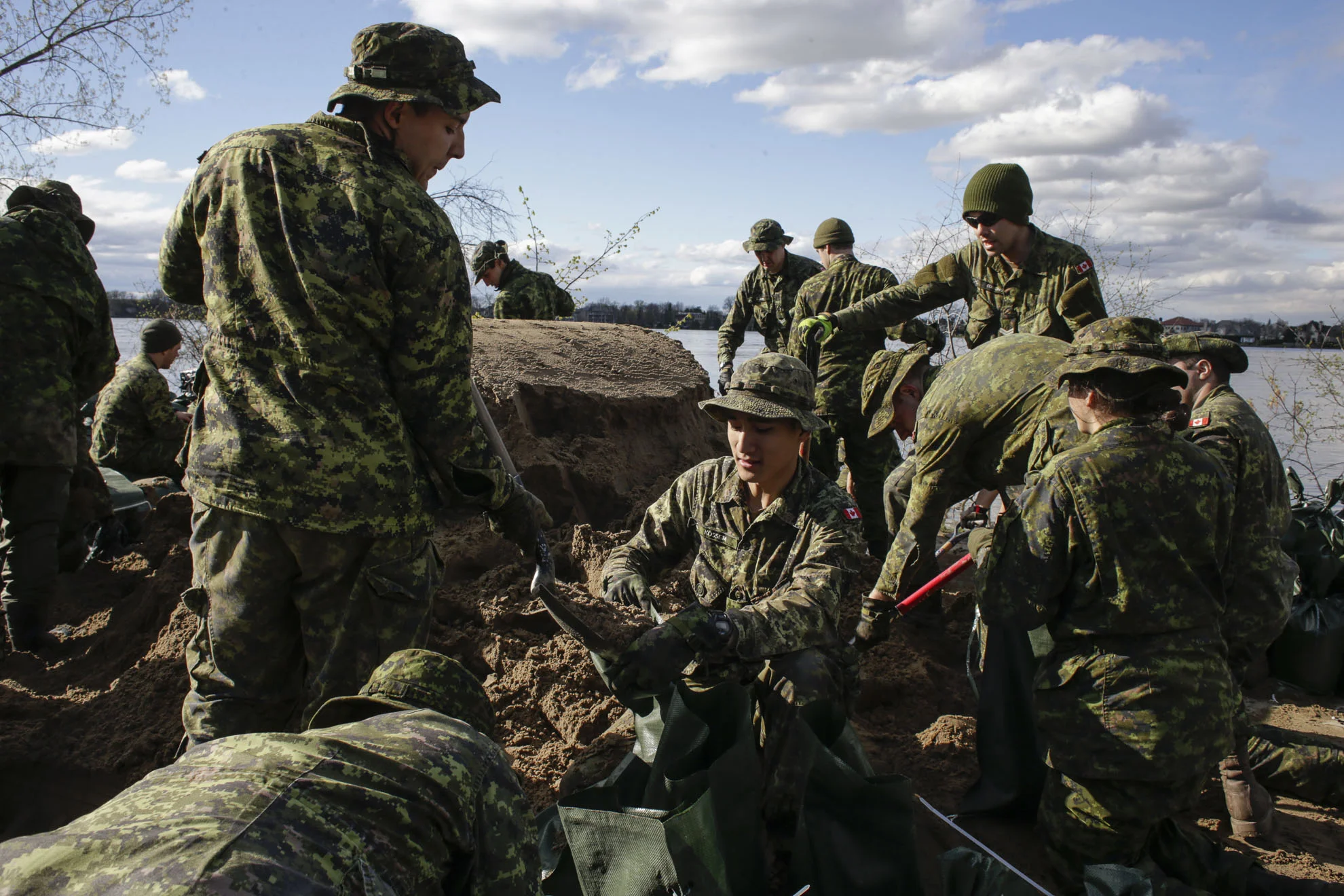  May 09, 2017 - Pierrefond, Quebec, Canada: Soldier of the 35th brigade of the Canadian Army fills sand bags to build a dam. (Normand Blouin/Polaris) 