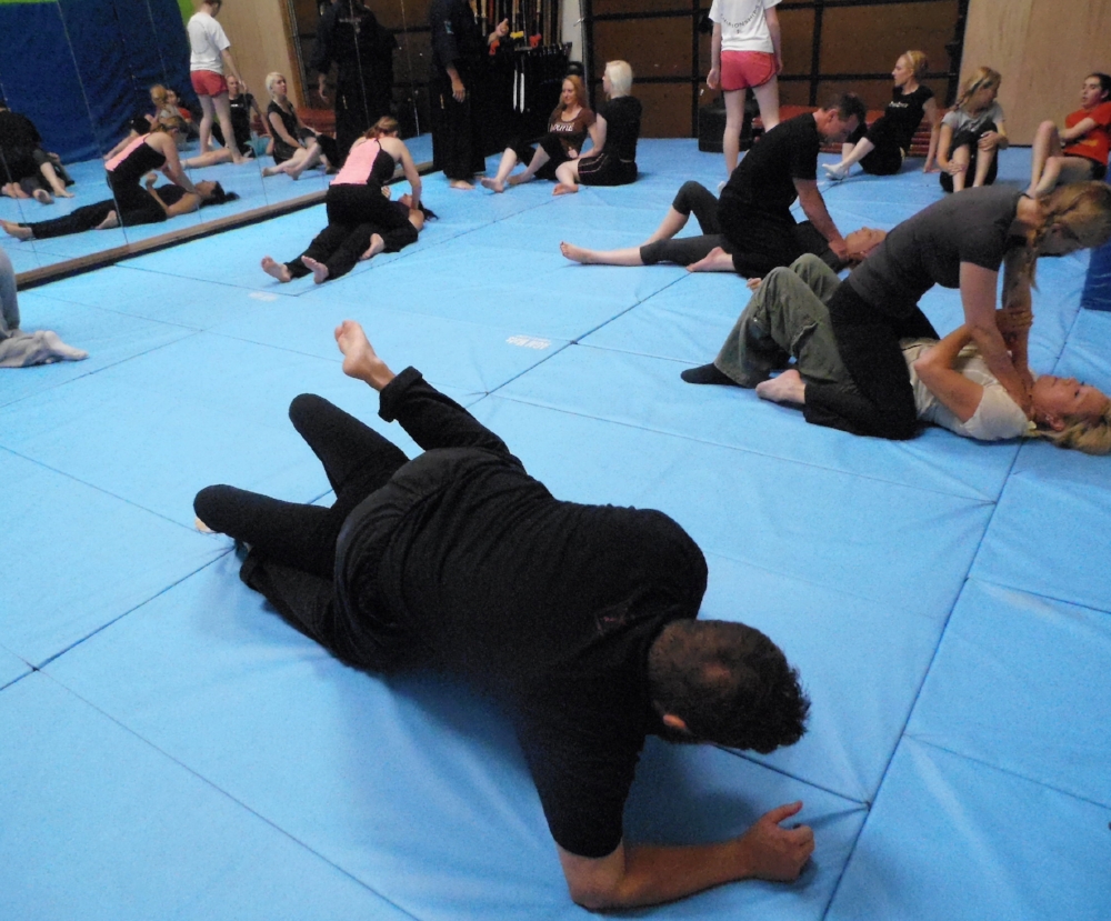 Woman makes a choke hold in self-defense training Stock Photo