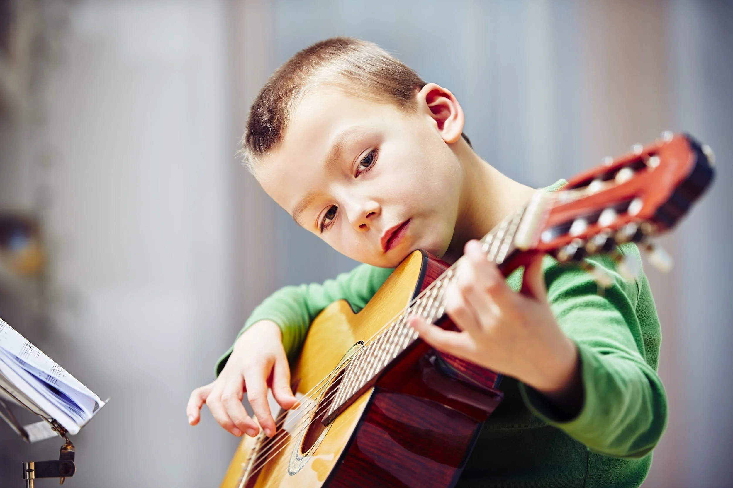 Child taking a private guitar lesson at Collingswood Music