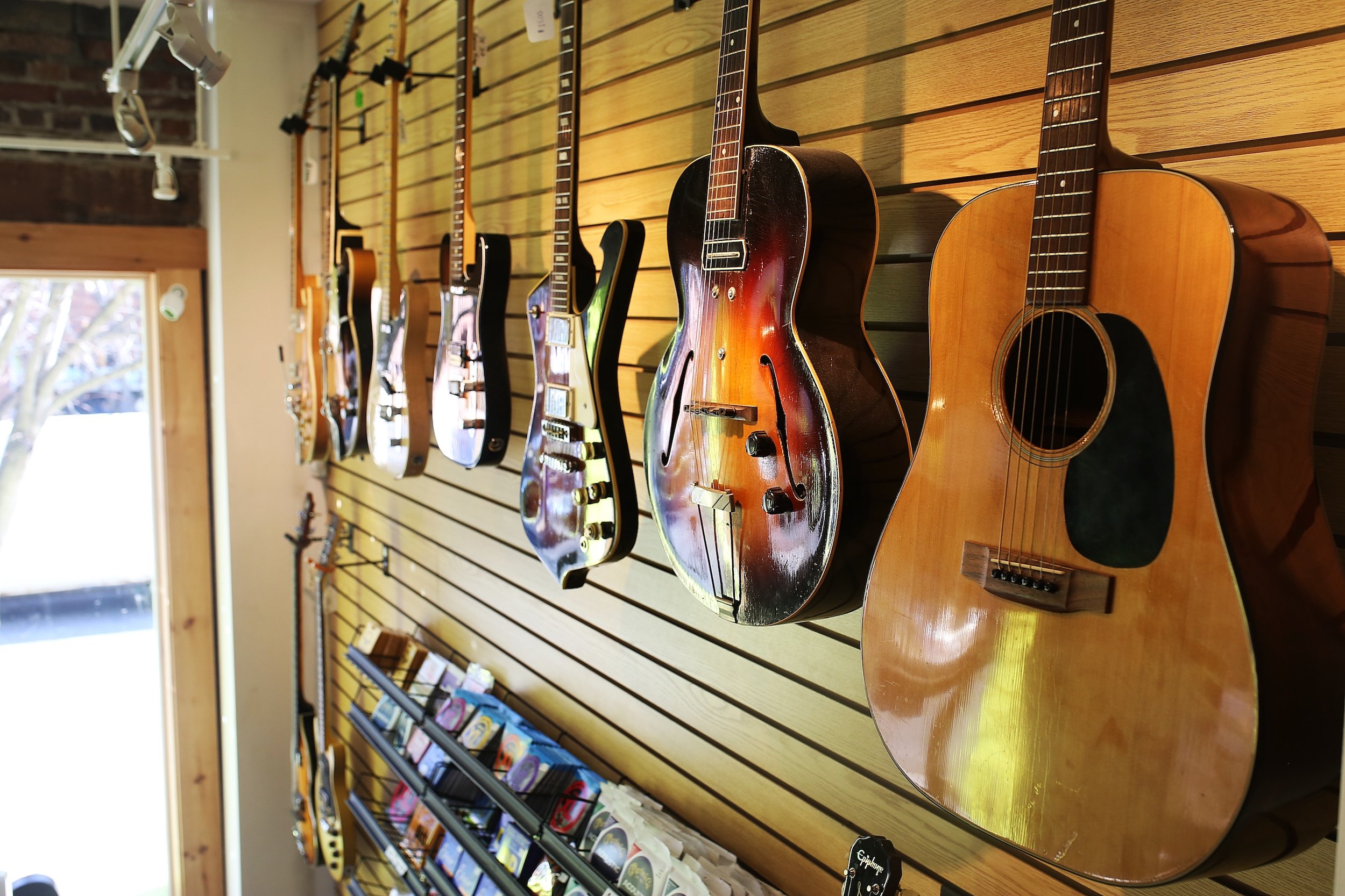 Selection of electric and acoustic guitars displayed in the Collingswood Music showroom
