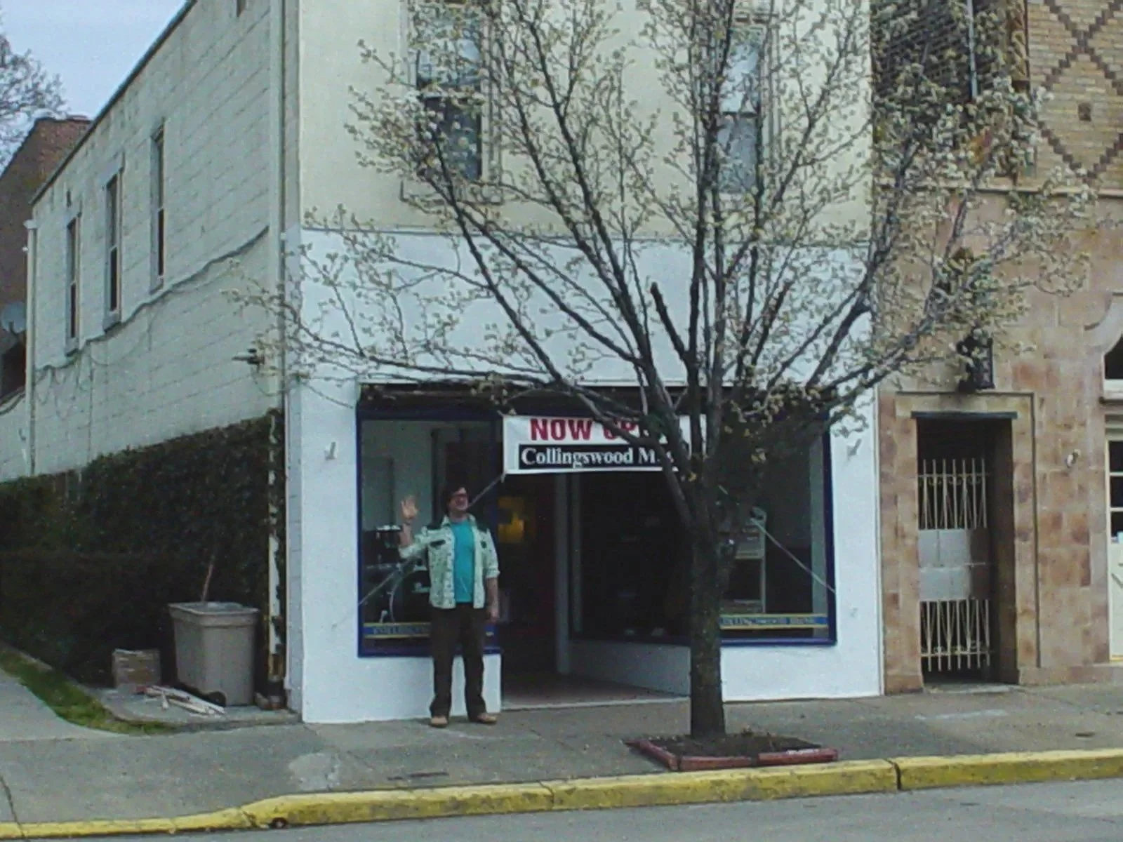 Original Collingswood Music storefront on opening day in 1997 with the owner standing outside under a “Now Open” banner