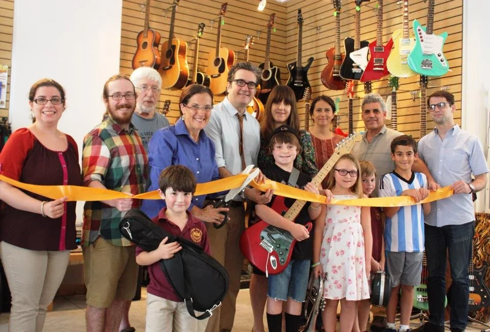 Ribbon cutting ceremony at the new Collingswood Music location with the owner, staff, students and community members