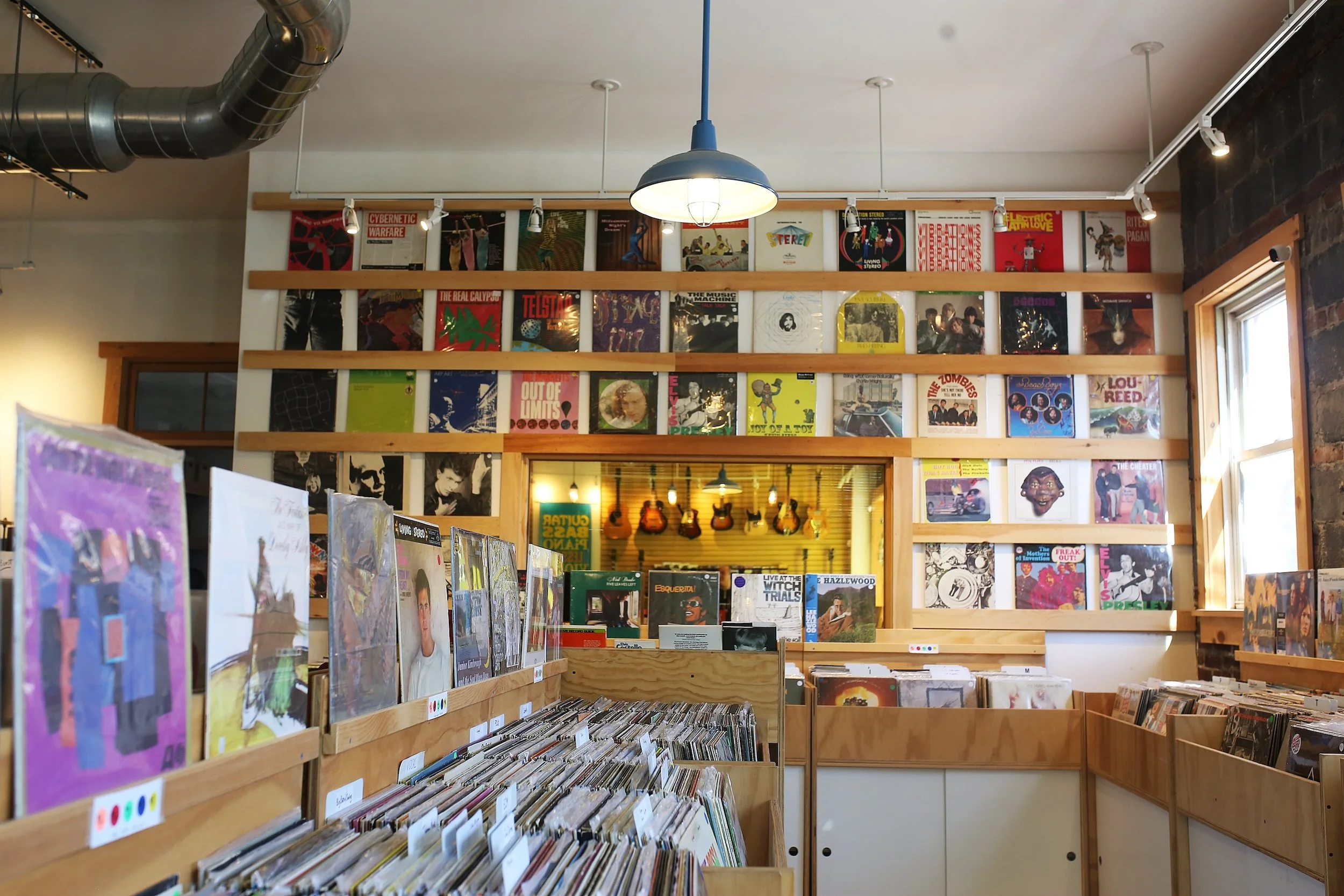 Wall of rare and collectible vinyl records inside Collingswood Music