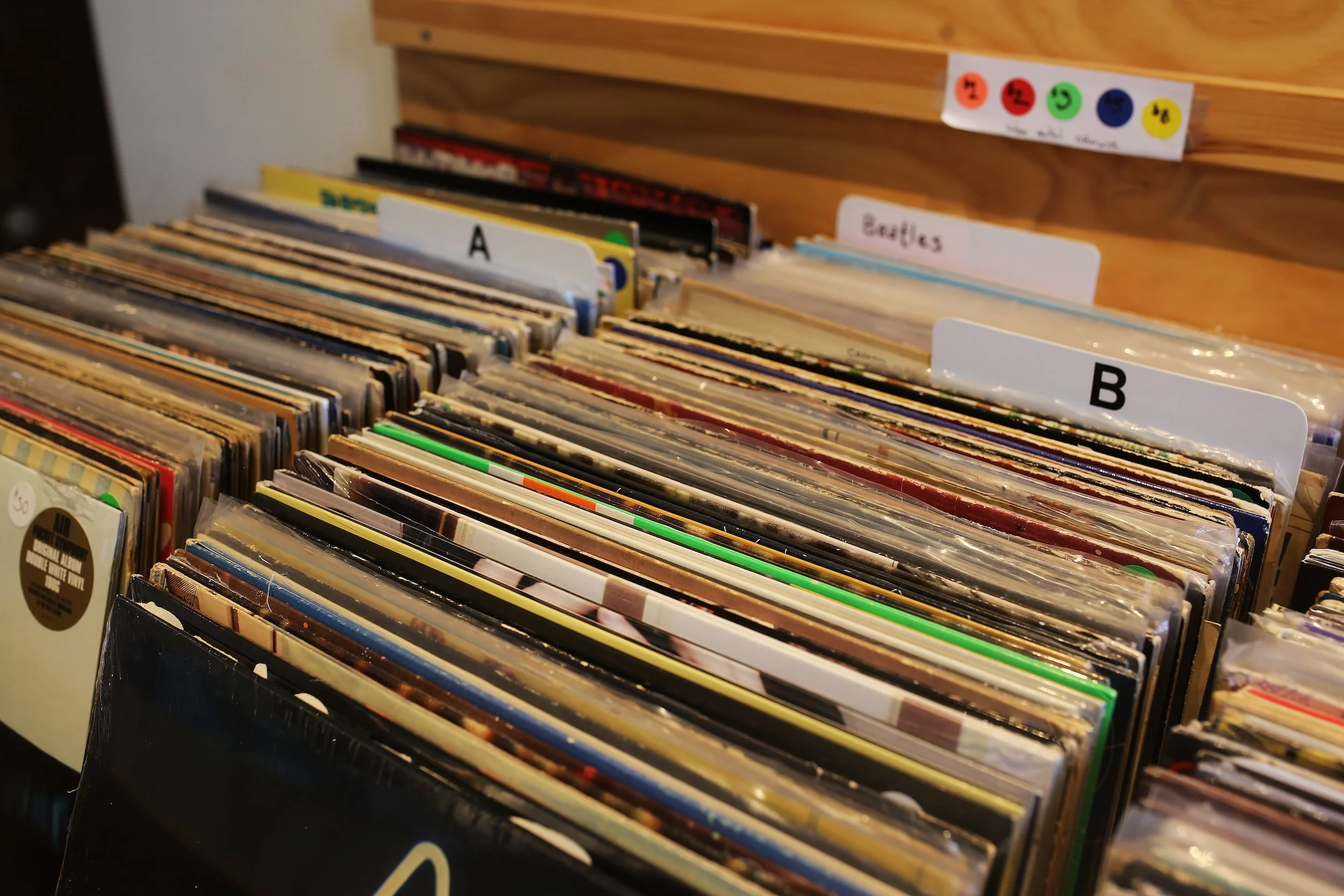 Close-up view of the vinyl records bins showing The Beatles section